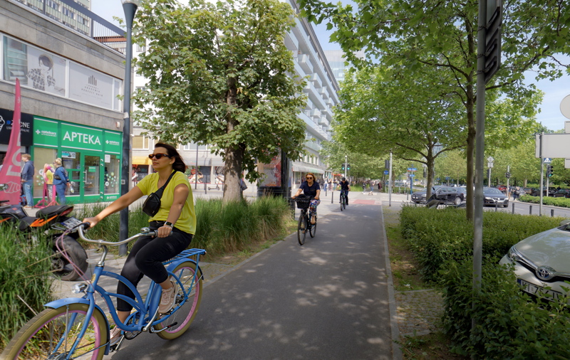 Woman bicycling in Warsaw 2